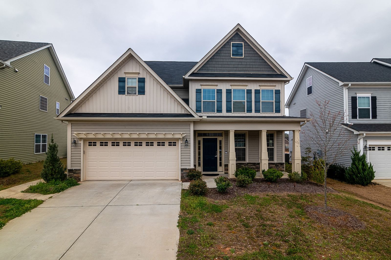 Two-story home with lap siding and crisp white trim and columns